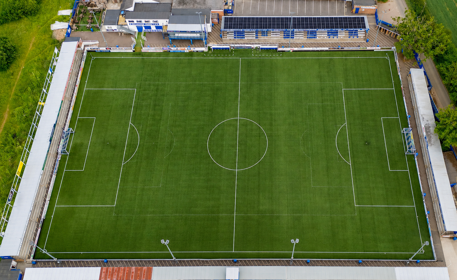 Aerial view of Billericay Town FC stadium with solar panels on the stand roof